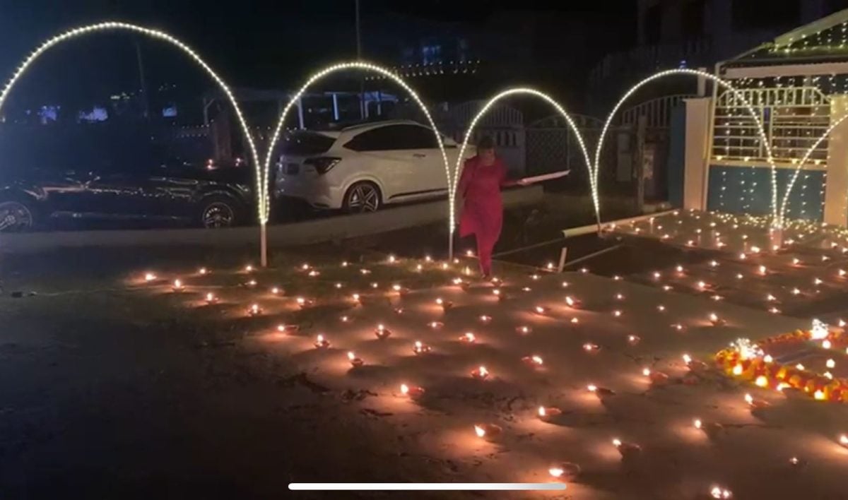  A woman in La Grange, West Bank Demerara lighting diyas
