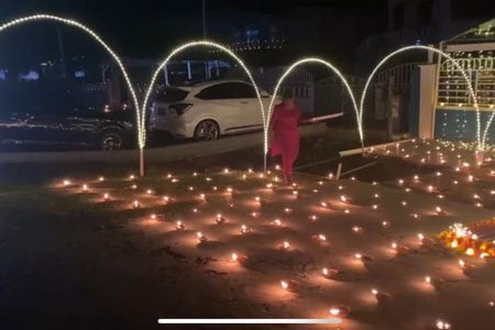  A woman in La Grange, West Bank Demerara lighting diyas
