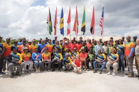 Locked & Loaded! President Irfaan Ali (centre) poses with respective competitors and officials following the launch of the West Indies Fullbore Shooting Championship, which commenced on Monday at the Timehri Rifle Ranges in Yarrowkabra, Linden Soesdyke Highway.