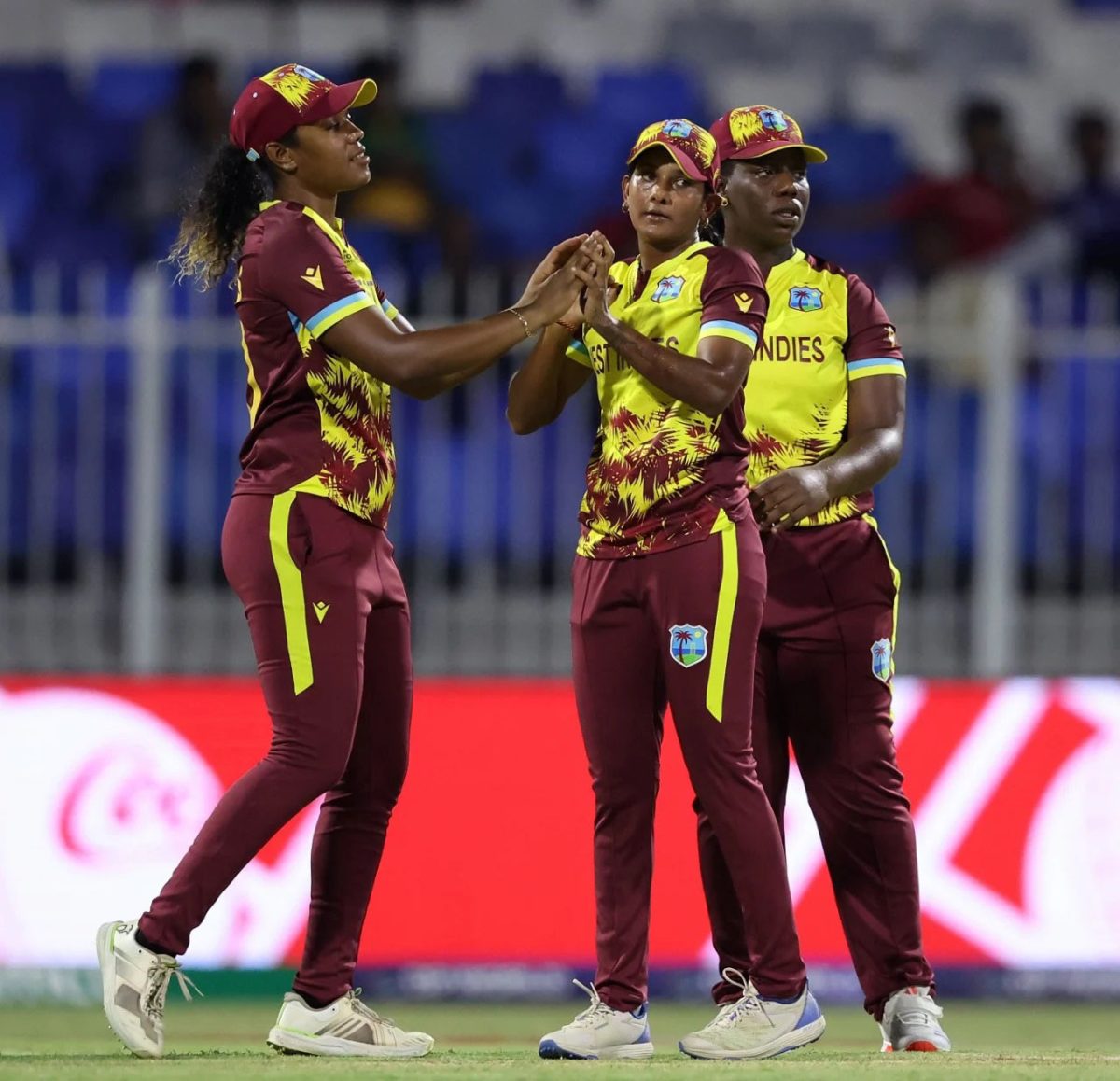 Karishma Ramharack (centre) is congratulated by teammates recording a dismissal. The spinner snared four wickets in the victory against Bangladesh.
