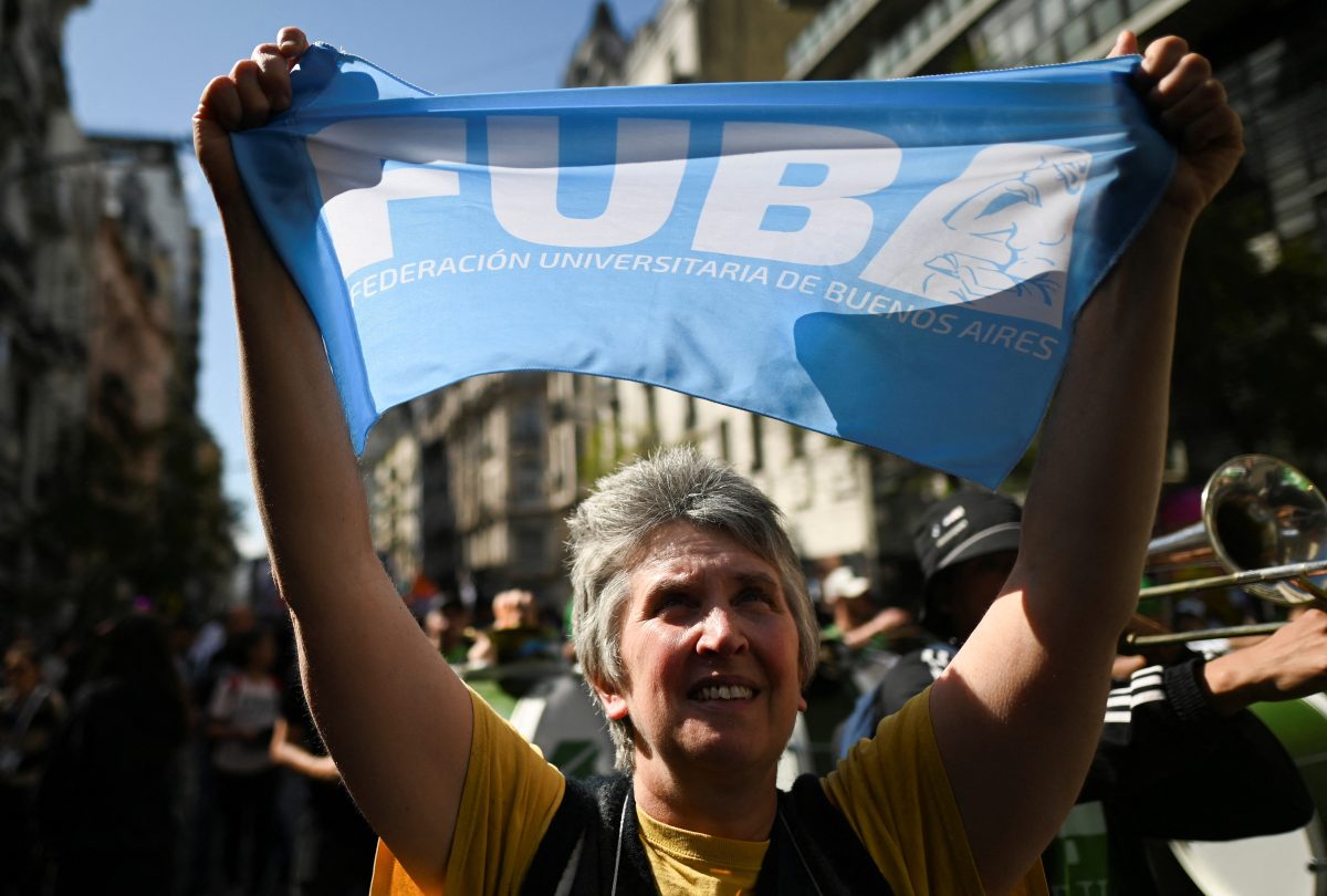 A person holds a sign as Argentine university students, unions, and social groups protest against Argentina’s President Javier Milei’s promise to veto a law to finance universities, in Buenos Aires, Argentina, October 2, 2024. REUTERS/Pedro Lazaro Fernandez