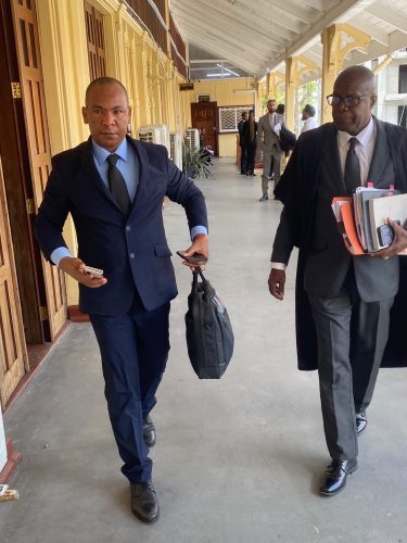 Dismissed: Assistant Police Commissioner Calvin Brutus and Attorney Earl Daniels in the corridors of the court yesterday shortly before his application was dismissed.