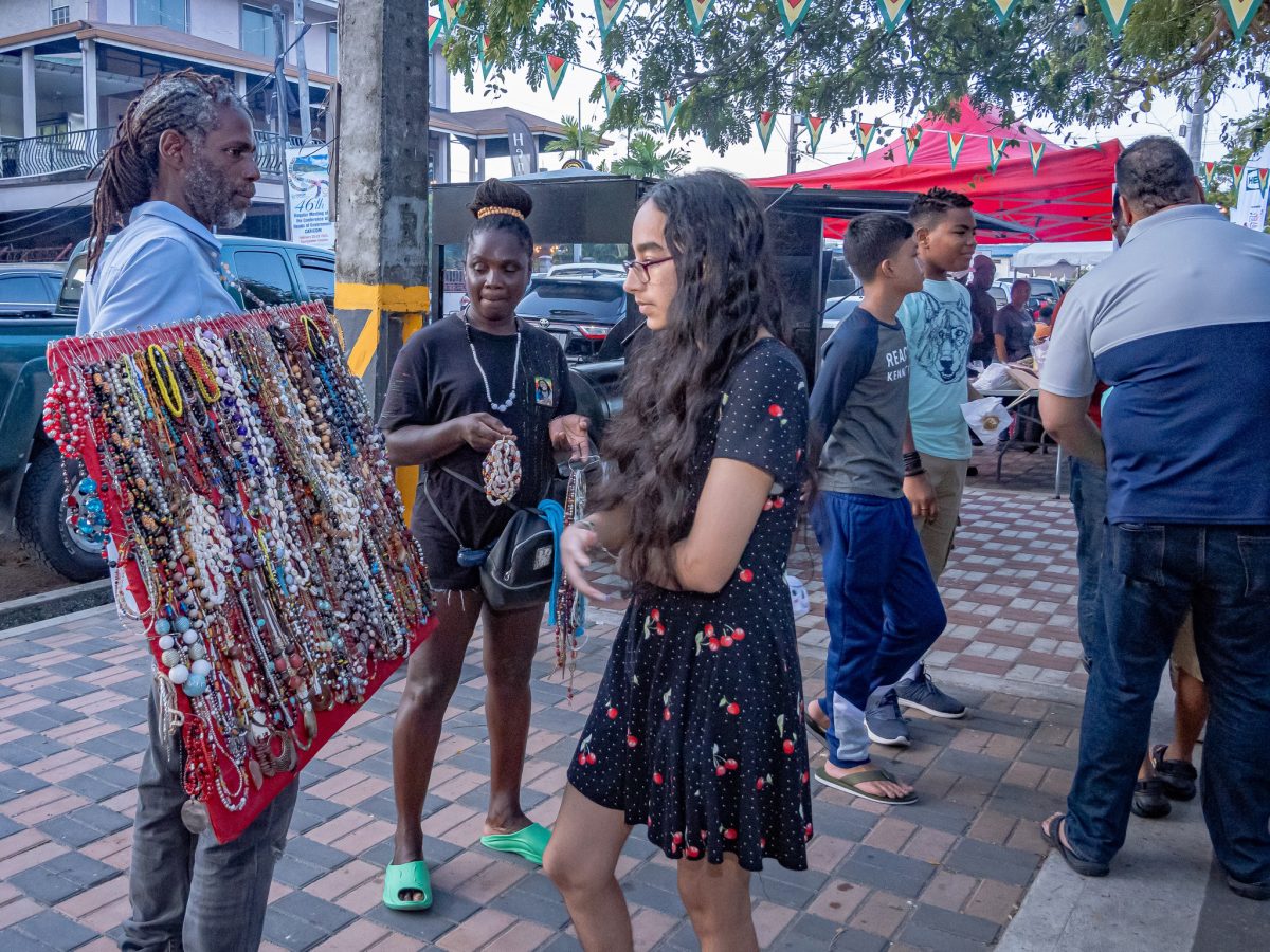 Difficult choice: This young woman had the difficult task of selecting a piece of hand made jewellery from a vendor at the recent Regional Food Festival on Main Street organised by the Ministry of Tourism, Industry and Commerce. (Ministry of Tourism, Industry and Commerce photo)