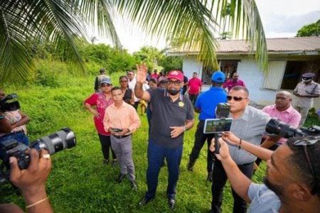 President Irfaan Ali (centre), Minister of Housing and Water, Collin Croal (right); Minister of Education, Priya Manickchand (left), with other officials at the housing site in Mabaruma