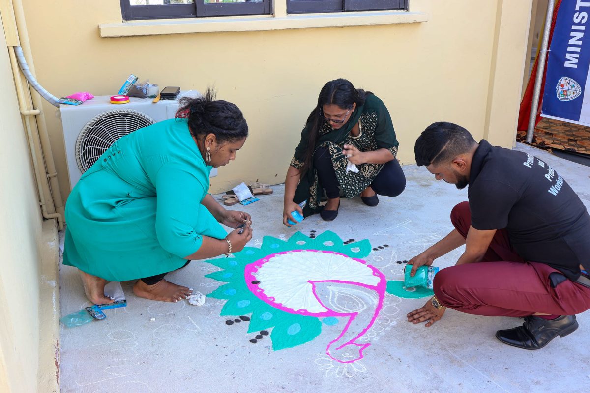 The Ministry of Labour yesterday marked the upcoming Festival of Lights with a Diwali Cultural Event and Rangoli Competition hosted at the ministry’s compound. In this photo one of the Rangoli displays is being worked on.
