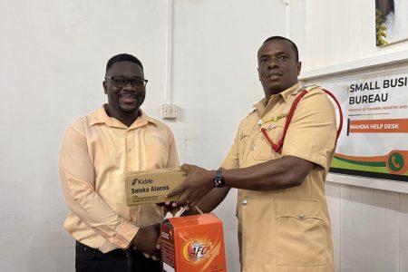 A smoke alarm being handed out during the outreach (Ministry of Home Affairs photo)