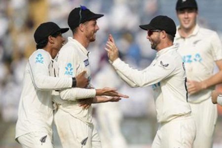 MATCH-WINNER: New Zealand’s Mitchell Santner, second from left, celebrates with his teammates after their win against India on the day three of the second Test, at the Maharashtra Cricket Association Stadium, in Pune, India, last Saturday. The Kiwis won the match by 113 runs for a 2-0 series lead as Santner proved the main destroyer, picking up 13 wickets in the game. —Photo: AP