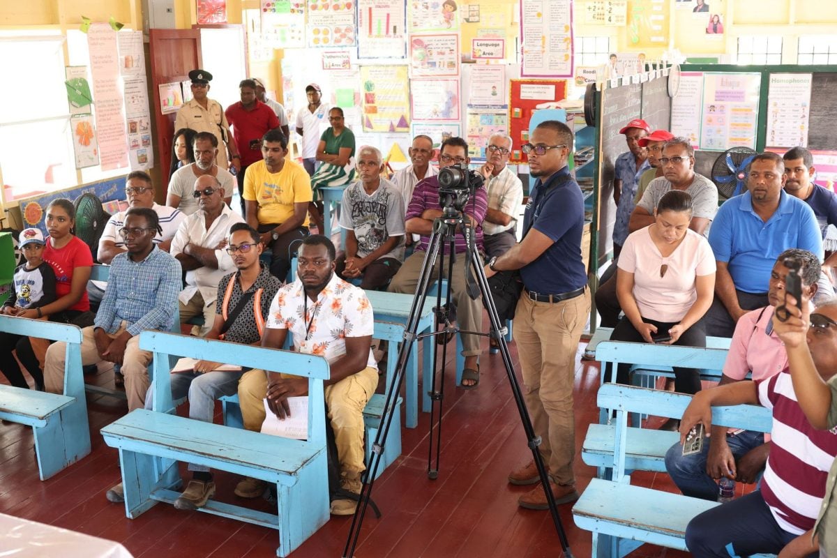 Wakenaam residents listening to Housing and Water Minister, Collin Croal