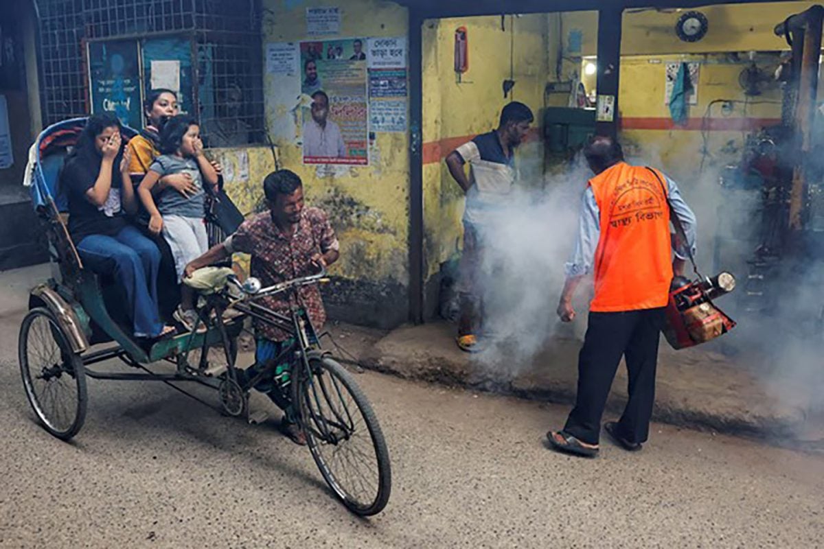 A city corporation worker sprays fumigator to control mosquitoes, as number of dengue infected patients increase, in Dhaka, Bangladesh, October 14, 2024