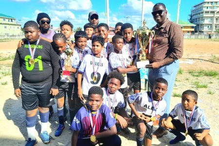 The victorious St. John the Baptist team receives their spoils after
winning the Bartica Primary Schools Football Championship.