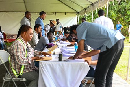 The Ministry of Public Works on Saturday announced that hundreds of contracts totaling over $5 billion were signed in Linden, Ituni and Kwakwani, Region Ten. In this photograph contractors in Linden are seen signing their contracts. (Ministry of Public Works photo)