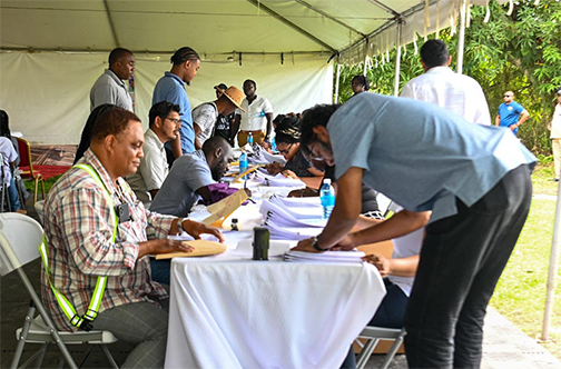 The Ministry of Public Works on Saturday announced that hundreds of contracts totaling over $5 billion were signed in Linden, Ituni and Kwakwani, Region Ten. In this photograph contractors in Linden are seen signing their contracts. (Ministry of Public Works photo)