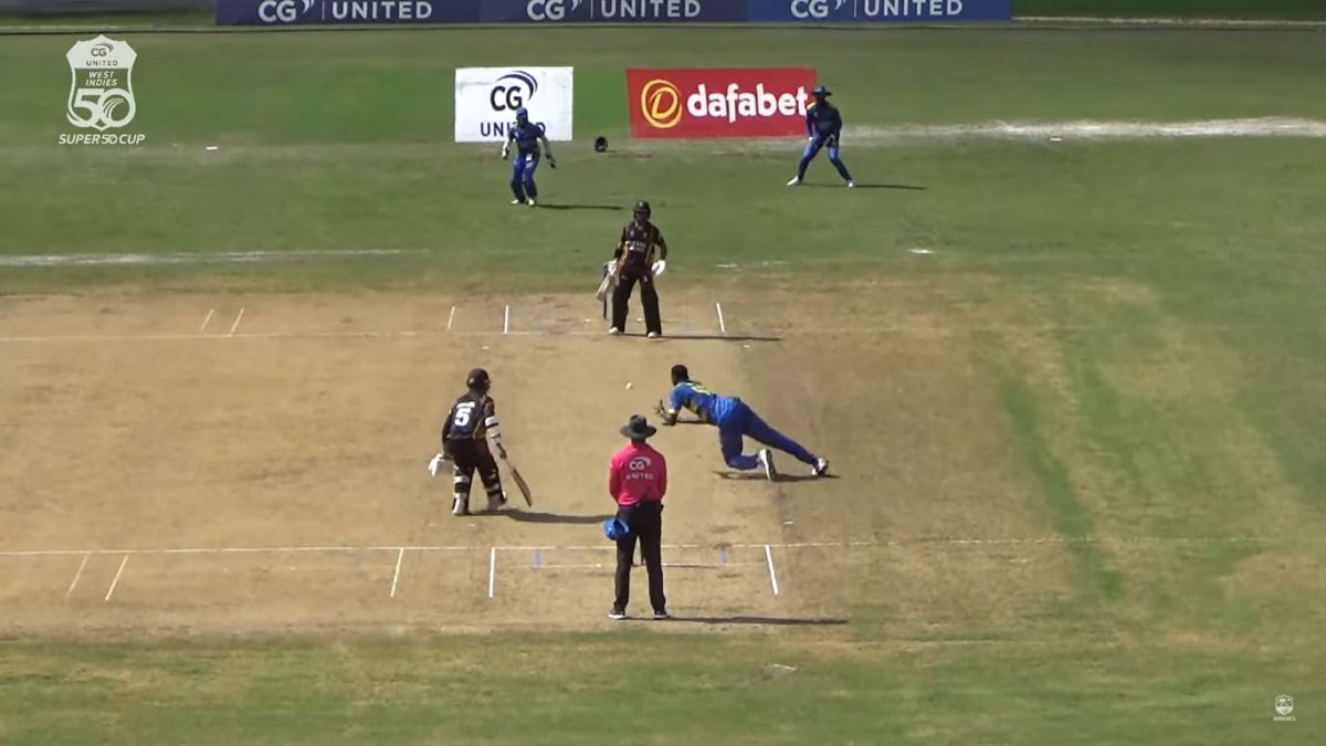 Fast-bowler Dominic Drakes is in the process of completing a catch to dismiss Matthew Nandu for 14.