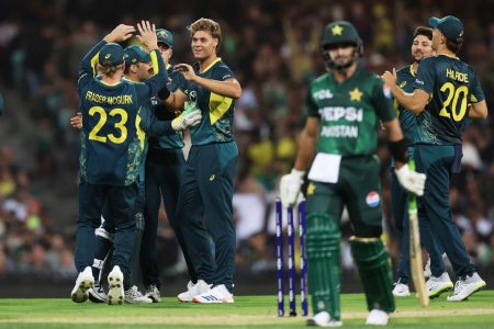 Spencer Johnson (4th from left) is congratulated by teammates
after dismissing Sahibzada Farhan for 5 (ESPN Cricinfo Photo).
