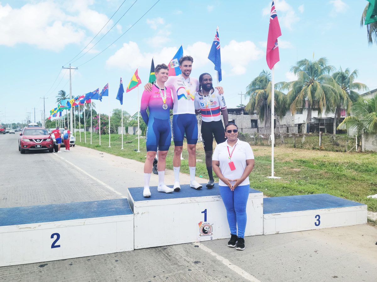 (From left): Senior Men’s Open silver medallist Kaden Hopkins (Bermuda), gold medallist Conor White (Bermuda), and bronze medallist Cory Williams (Belize) posed for a photo opportunity with GCF’s Denise Hopkinson.