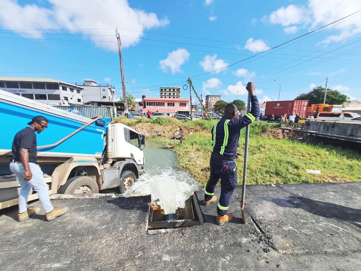 GWI staff assessing the damage to the pipe at Dennis Street.