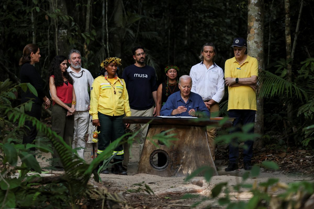 U.S. President Joe Biden signs a proclamation designating November 17 as "International Conservation Day", next to Henrique Pereira, Director of the National Institute for Research in the Amazon, Filippo Stampanoni, General Director of MUSA – Museu da Amazonia, Carlos Nobre, Earth System Scientist and Nobel Prize Winner, Kelliane Wapichana, General Secretariat of the Women's Movement of the Indigenous Council of Roraima, Chief Kokama, Chief of the Kokama people, Simone Xerente, Leader and Member of Xerente, Camila Ribas, Curator of the Biological Collections of Genetic Resources and Birds at National Institute for Amazonian Research, and Peter Fernandez, Co-Founder and CEO at Mombak during his tour at the Museu da Amazonia in Manaus, Brazil, November 17, 2024. REUTERS/Leah Millis