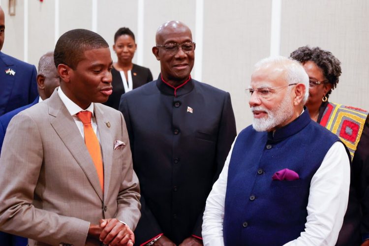 Indian Prime Minister Narendra Modi (right) with CARICOM Chairman, Grenadian Prime Minister Dickon Mitchell (left). Trinidadian Prime Minister Keith Rowley is at centre. (CARICOM photo) 