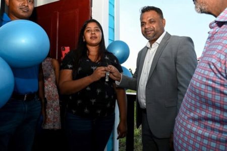 Minister within the Ministry of Public Works, Deodat Indar hands over the keys to Anisa Deoraj for her new home at Meten-Meer-Zorg (DPI photo)
