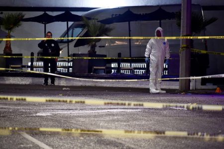 Police officers work at a crime scene where gunmen entered a bar killing and injuring several people, in Santiago de Queretaro, Queretaro state, Mexico November 10, 2024.