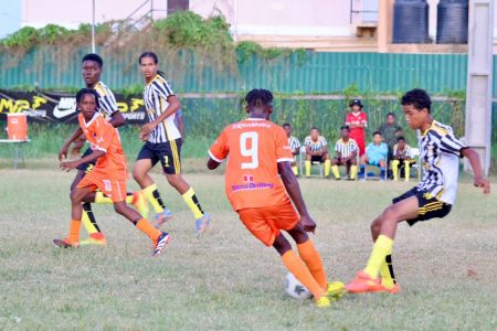 Action between Dolphin and South Ruimveldt (orange) in the Republic Bank U-18 Schools Football League.