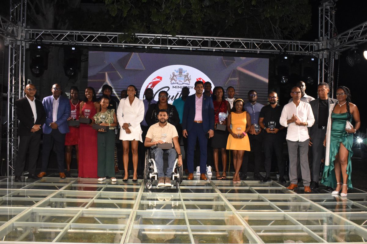 Minister of Culture, Youth, and Sport Charles Ramson Jr. (centre) poses alongside the respective category winners at the conclusion of the National Sports Awards ceremony. (Ministry of Culture, Youth and Sport photo)