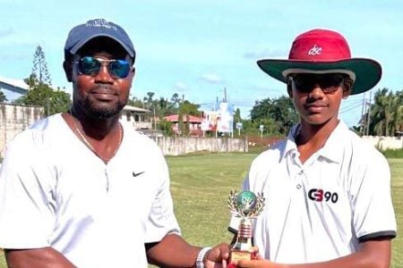 Cush Seegobin (right) receives his man of the match award from former West Indies batsman Travis Dowlin.
