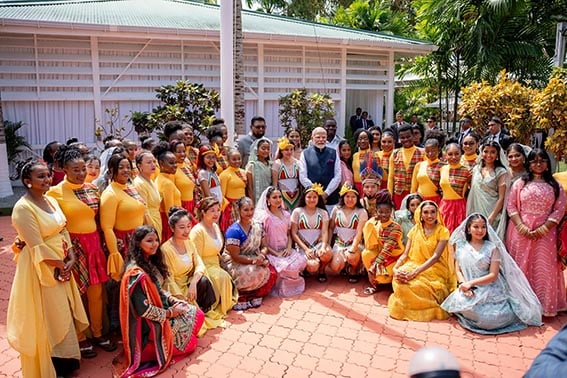 President Irfaan Ali and Indian Prime Minister Narendra Modi at State House  yesterday with dancers who featured at several events as part of the official programme of activities. (Office of the President photo) 