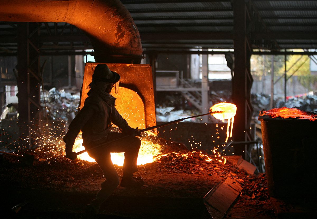 FILE PHOTO: A labourer works inside a steel factory on the outskirts of Jammu January 2, 2014. REUTERS/Mukesh Gupta/File Photo