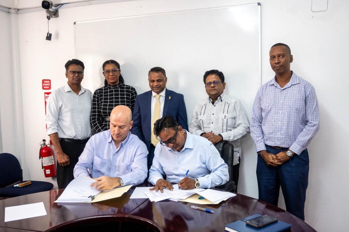 GPL Executive Management Committee Head  Kesh Nandlall (right) and Managing Director of the Americas, UCC Holdings  Antonio Neto signing the deal. (Ministry of Finance photo