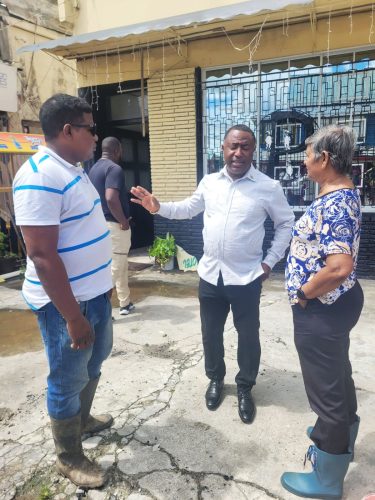 Billy La Bennette (left) and his mother Mavis (right) speaking to New Amsterdam Mayor Wainright McIntosh yesterday.