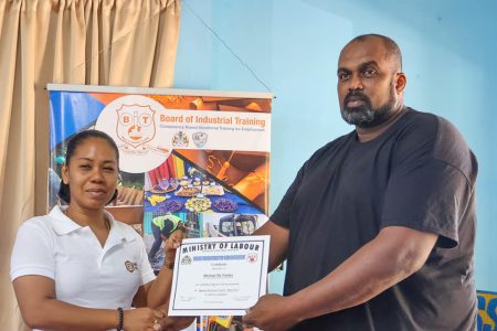 Michael De Fraitias (right) receiving his certificate 