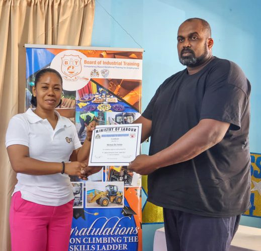 Michael De Fraitias (right) receiving his certificate 