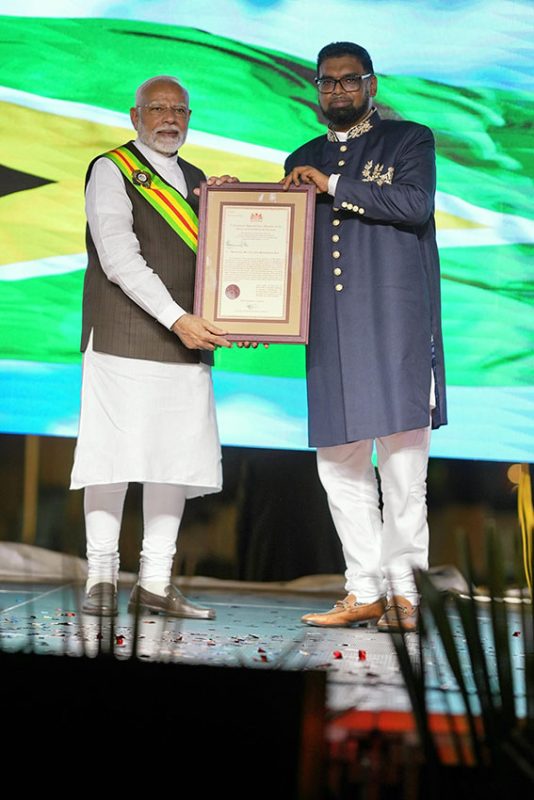 Indian Prime Minister Narendra Modi (left)  was conferred on Wednesday night by President Irfaan Ali with  Guyana’s highest national honour, the Order of Excellence.  (Office of the President photo)