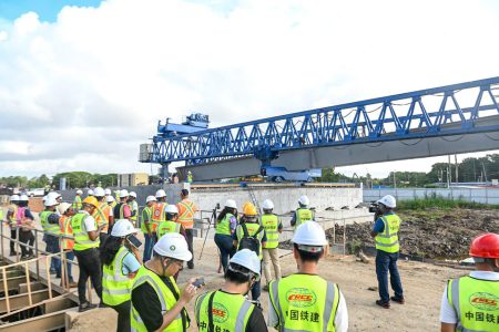 The first precast girder was yesterday morning launched for the new Demerara River Bridge, marking a new phase of the construction process, the Ministry of Public Works said.
The precast girder is a horizontal beam that supports the deck of a bridge and the weight of traffic.
Minister of Public Works, Juan Edghill was present to offer remarks and witness this historic event on the western end of the bridge. (Ministry of Public Works photo)
