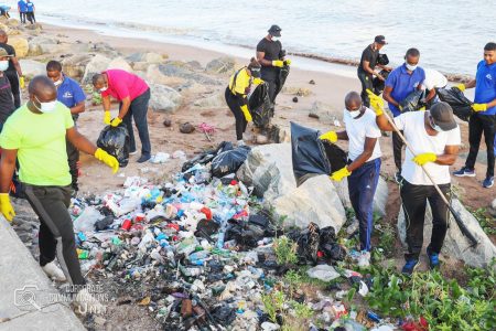 A large contingent of police officers and ranks early yesterday morning participated in the National Environmental Enhancement initiative at the seawall. (Guyana Police Force photo)