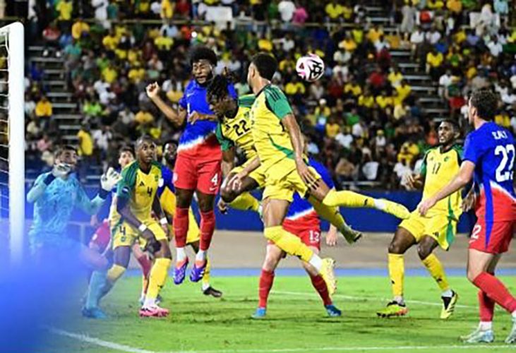 Jamaica’s Greg Leigh (centre) and Mason Holgate (right) rise for a header against United States defender Mark McKenzie during a Concacaf Nations League quarterfinal game at the National Stadium yesterday. The Reggae Boyz lost 0-1.
