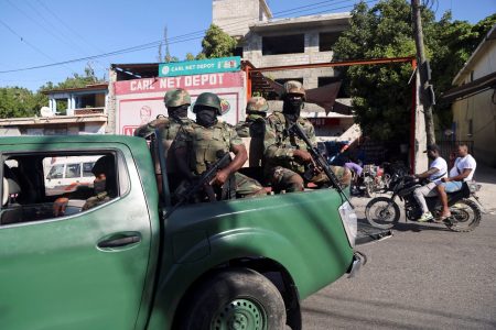 Members of the Haitian Armed Forces patrol the area as people flee homes following the armed gangs violence over the weekend, many grouped behind an alliance known as Viv Ansanm, at the Poste Marchand suburb, in Port-au-Prince, Haiti December 9, 2024. REUTERS/Ralph Tedy Erol
