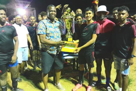 Potaro Strikers receives the championship trophy after
winning the Bartica Football Association Senior Men’s League.
