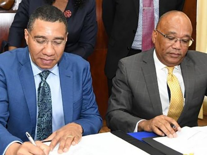 Prime Minister Andrew Holness (left) and his business partner Norman Brown