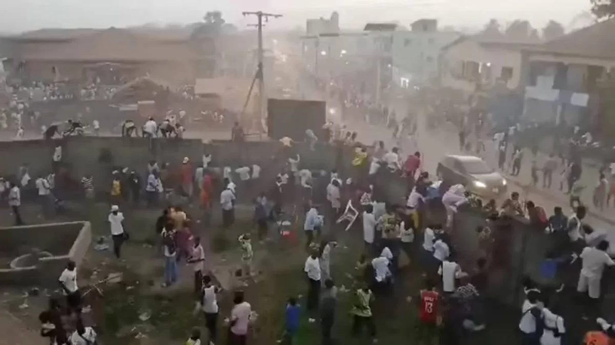 People scramble in Nzerekore, Guinea, where local officials said a deadly stampede ensued at a stadium following fan clashes during a soccer match, December 1, 2024, in this still image obtained from a social media video. Social media via Reuters