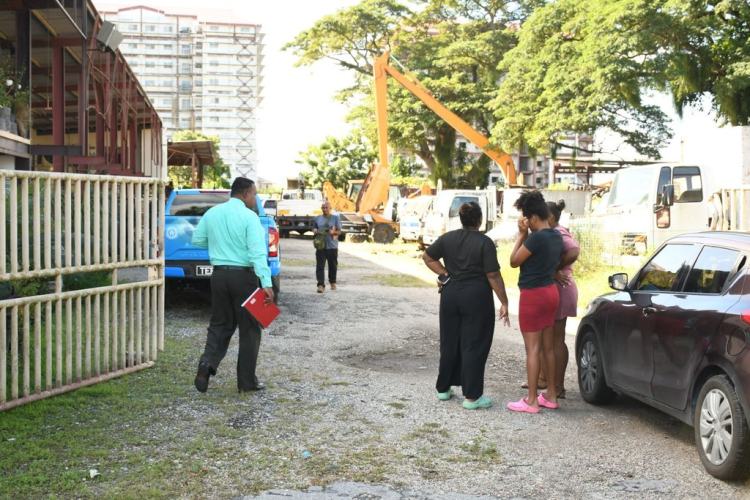 Chaguanas businessman Tariq Razak’s relatives console each other at the scene of his murder on Eric Street, Chaguanas, yesterday.