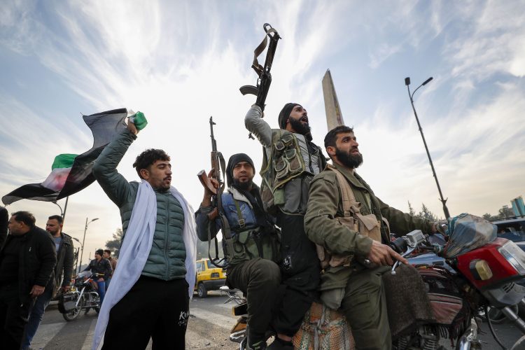 Syrian opposition fighters celebrate after the government collapsed in Damascus, Syria, on December 8. Omar Sanadiki/AP