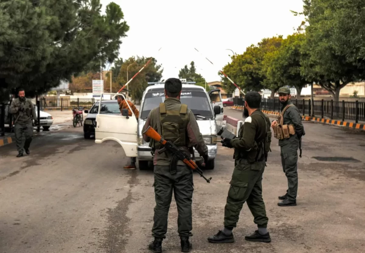 Soldiers stop a car at a checkpoint after taking control of the port of Tartous earlier this month (AFP)