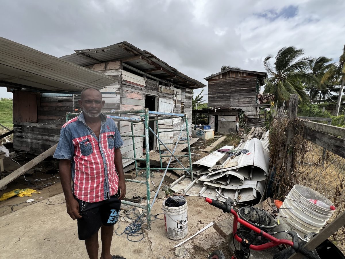 Ganeshram Sahobia standing in front of his collapsed shack after it was ‘fixed’