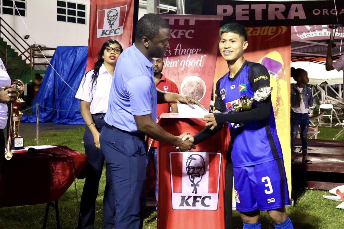 Raydon Krammer collected his MVP accolade from Narada Wilson, a scout and consultant at Academia de Futebol Real Brasil 
