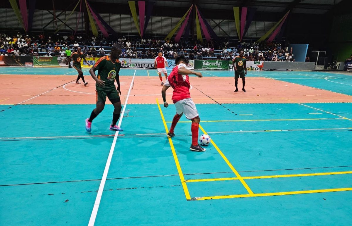 MacGuiver Parks (right) of Region #9 attempts to shield the ball while being watched closely by Adrian Aaron of Bent Street.