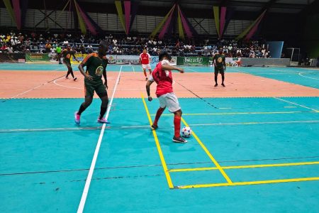 MacGuiver Parks (right) of Region #9 attempts to shield the ball while being watched closely by Adrian Aaron of Bent Street.