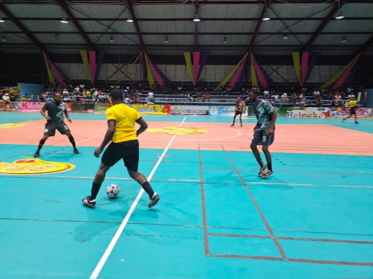 Action in the Kashif and Shanghai National Futsal Championship between Showstoppers (gray)and Stabroek Ballers B
