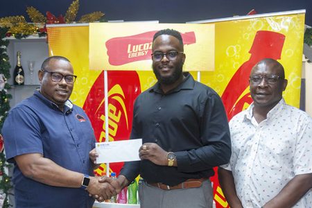 Petra Organisation’s Troy Mendonca (left) receives the sponsorship package from
Lucozade Business Unit Head Triston Freeman.